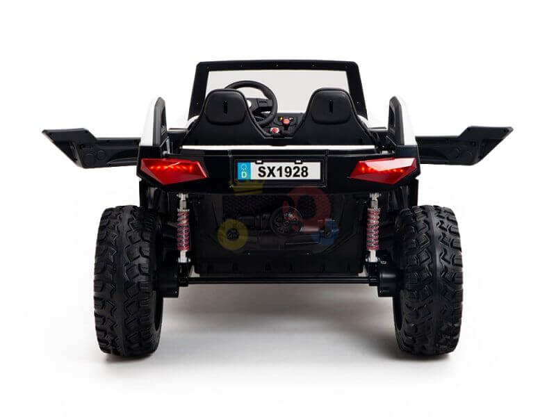 A rear view of a black Kids XXL Edition toy car features large rubber wheels, red suspension springs, and a steering wheel. Its license plate reads SX1928, and the vehicle boasts upward-swinging doors for added flair.