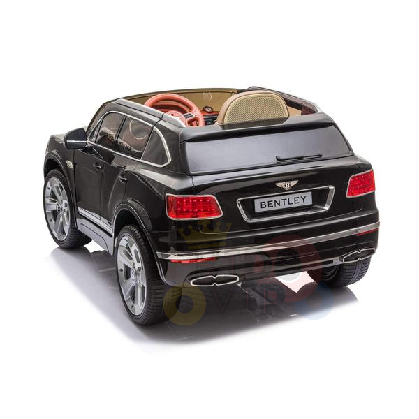 The Black Licensed Bentley Bentayga Complete Edition 12V Kids Ride On Car With RC features red taillights, a rear Bentley logo, tan leather seat, and realistic dashboard. It also includes a parental remote and is beautifully photographed from the rear angle.