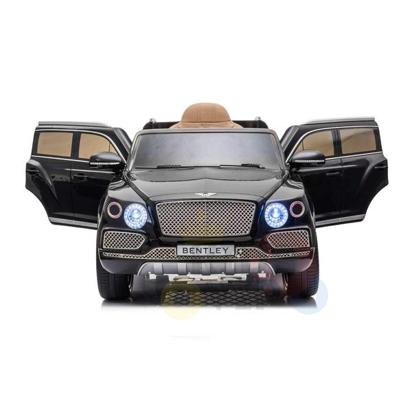 The Black Licensed Bentley Bentayga Complete Edition 12V Kids Ride-On Car features open front doors, detailed headlights, a BENTLEY license plate, tan leather seat interior, and realistic wheels. Its perfect for kids and includes a parental remote control.