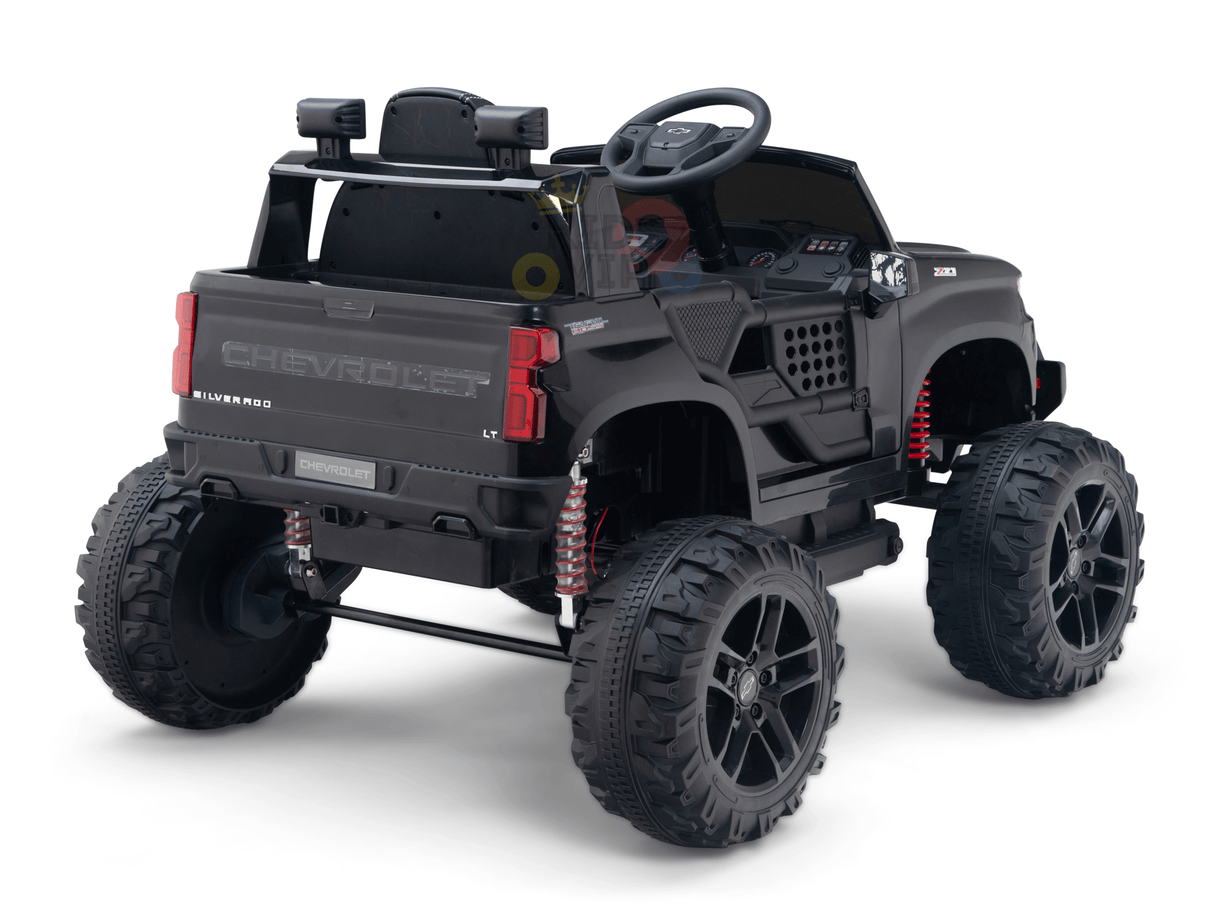 The Black Official 24V Chevrolet Silverado Lifted Kids Ride-on Truck features large rugged wheels, detailed dashboard, realistic detailing, off-road suspension springs, and is powered by a 24V battery for an authentic driving experience.