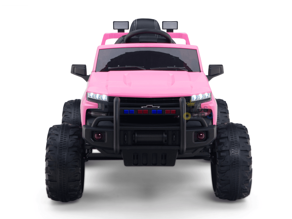 The Pink 24V Chevrolet Silverado Kids Licensed 1 Seater Ride On Lifted Truck features oversized black tires, a black grille guard, and a sleek black seat. This mini truck offers realistic details like mirrors and headlights for an authentic ride-on experience.