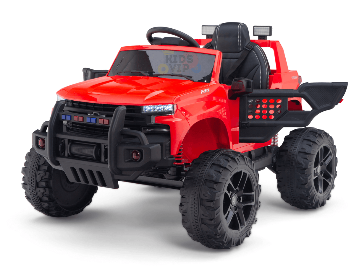 The Red 24V Chevrolet Silverado Kids Licensed Ride-On Truck features a rugged pickup-inspired design with oversized black tires, detailed front grille, visible steering wheel, and an open back revealing a small cargo area for adventurous play.