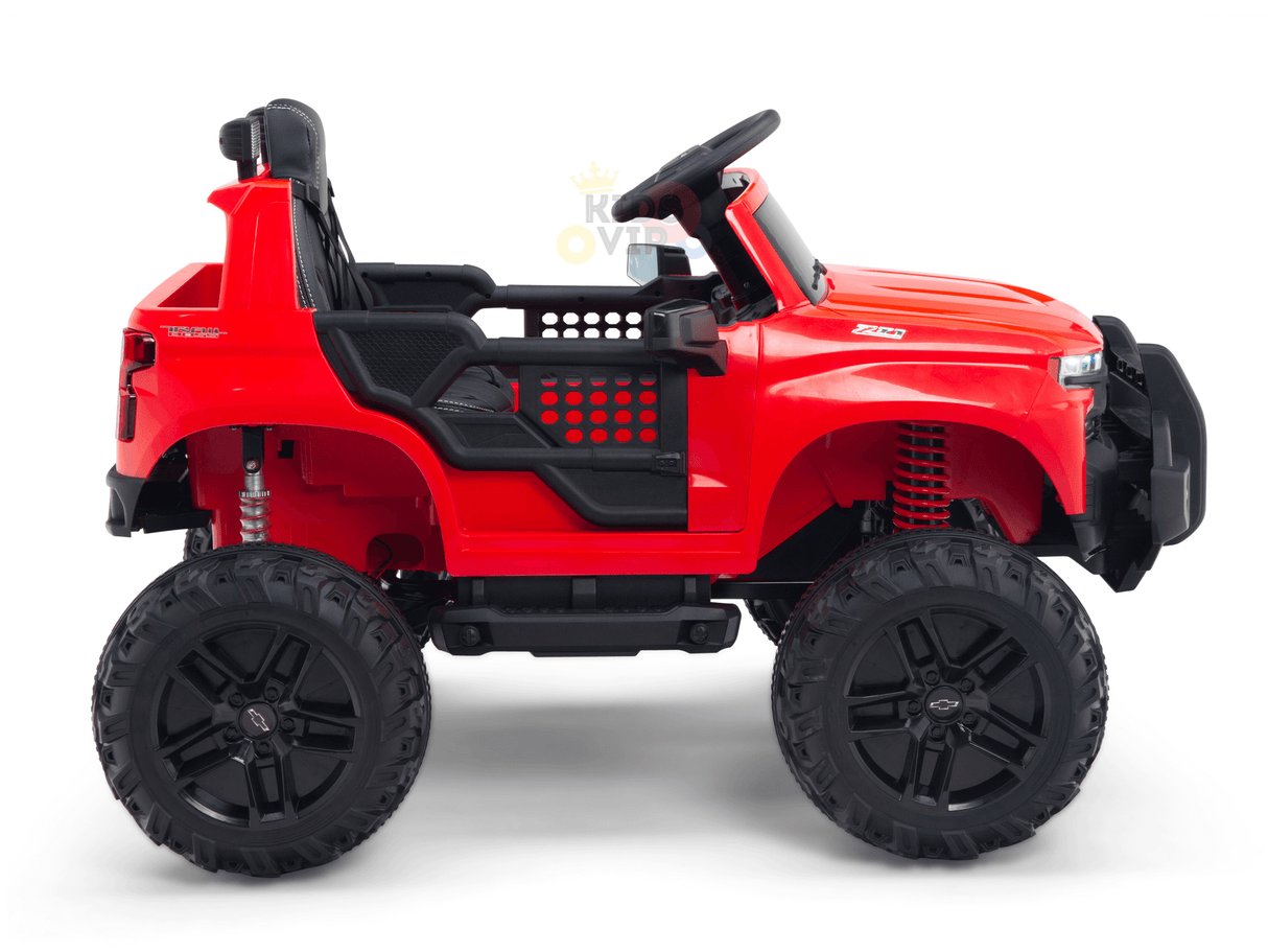 The Red 24V Chevrolet Silverado Ride-On Truck is a child’s one-seater with oversized wheels, an open-top design, a steering wheel, and rugged details for a realistic off-road look.