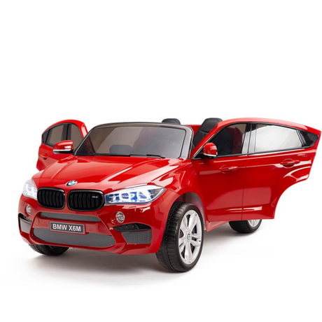 The Red 12V Licensed XXL BMW X6 Ride On Car with Remote Control boasts open doors, shining headlights, side mirrors, and a detailed front grille for style and functionality.