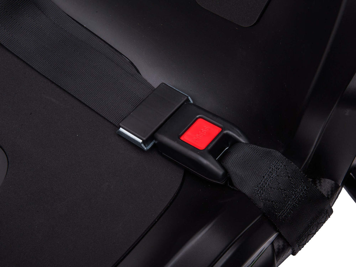 Close-up of a black car seat with a safety belt fastened into a buckle, featuring a prominent red release button similar to controls in the Big Kids Powerful 24V Speedster Drifting Go-Kart. Shadows emphasize the smooth texture reminiscent of high-speed karting adventures.