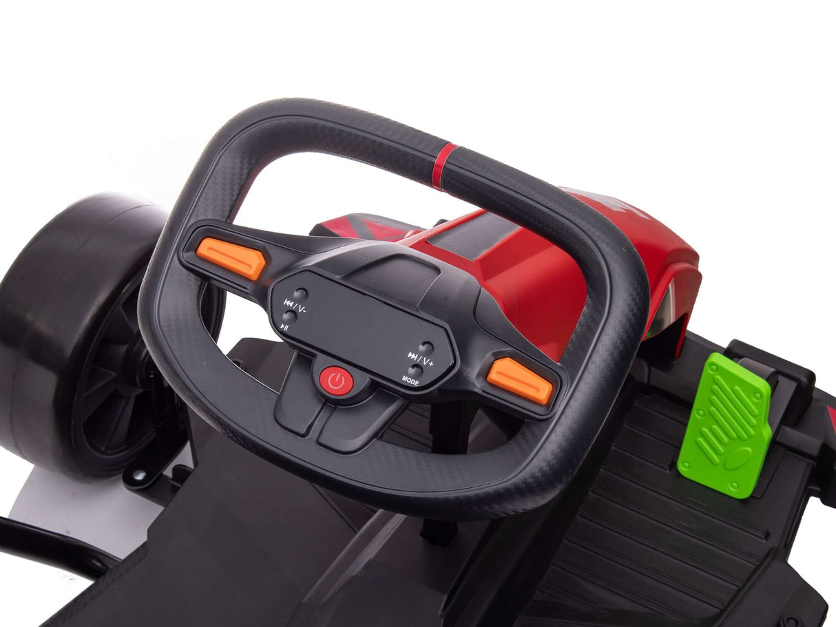 Close-up of a steering wheel on a red Big Kids Powerful 24V Speedster Drifting Go-Kart features orange buttons, a red center power button, and behind it, a green pedal is visible. It includes black seat details and EVA-rubber wheels for smooth drifting.