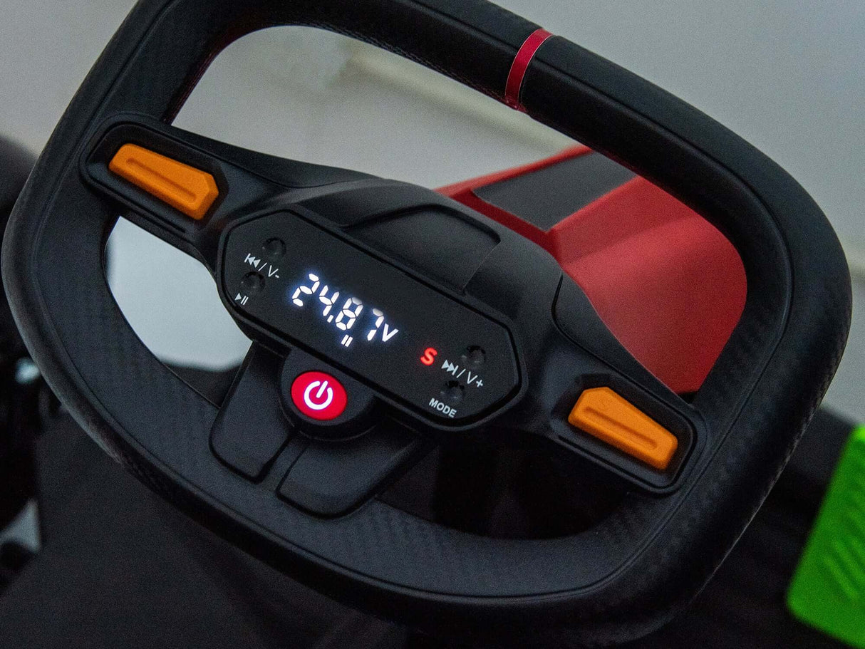 A close-up of the Big Kids Powerful 24V Speedster Drifting Go-Karts steering wheel highlights a digital display showing 24.8 V, indicating its 24V HP motors, with buttons including an illuminated power button. The black wheel with orange accents complements the go-karts red body and EVA-rubber wheels.