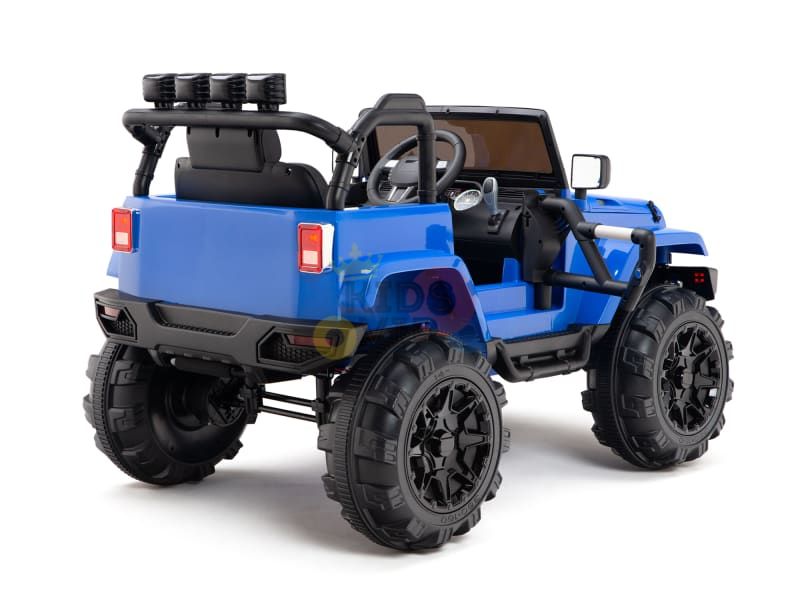 The Blue 12V Sport Edition Trailcat Big Wheels Kids Ride on Truck features a rugged SUV design with large black tires, side mirrors, and a steering wheel. It includes black roll bars and rear lights for an off-road look, displayed diagonally to highlight its side and rear.