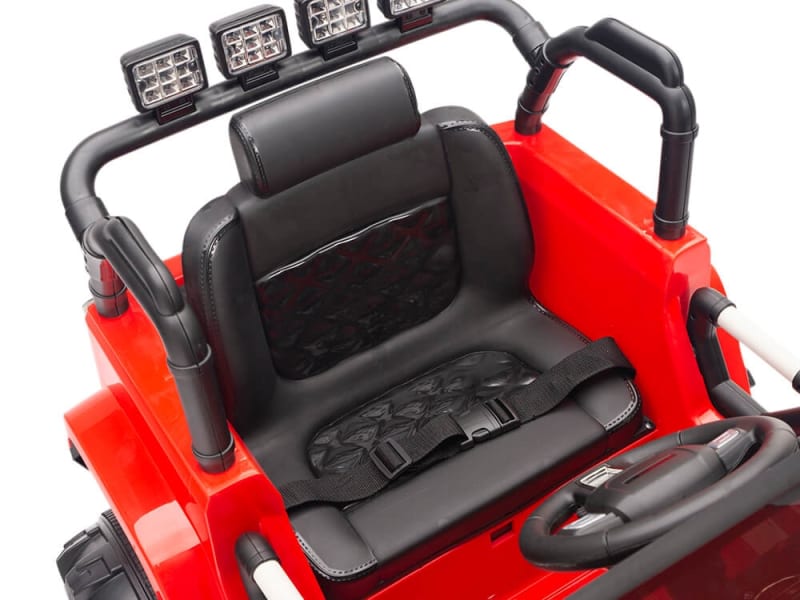 A close-up of the Red 12V Sport Edition Trailcat Big Wheels Kids Ride on Trucks interior showcases a black seat with a seatbelt, steering wheel, and overhead LED lights, designed for children with added safety from a parental remote control.