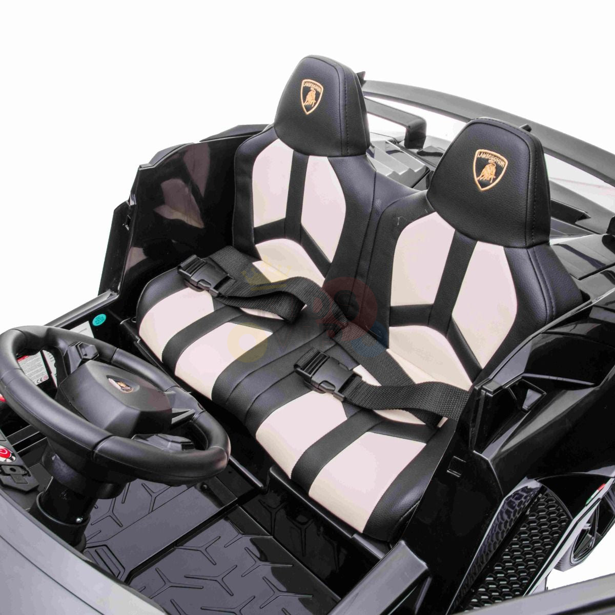The Black 24V Lamborghini SVJ Ultimate Drifting Car is a childrens toy with a sleek black design, featuring drifting wheels, a steering wheel, two-tone black and white seats with seatbelts, and a logo on the backrests for an authentic luxury sports car look.