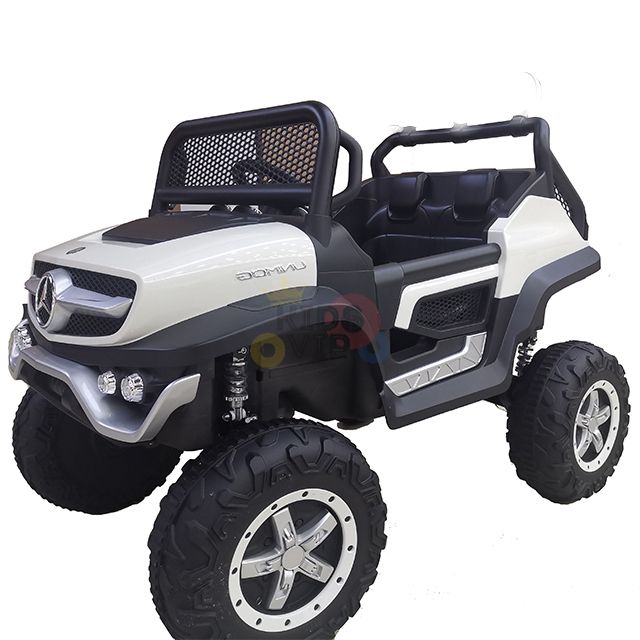 The White 12V/4X4 Official Mercedes Unimog Junior Ride On UTV is a realistic toy off-road vehicle with large, rugged tires, an open cabin, and a sleek black and white design resembling a luxury SUV with front bumper and headlights. Perfect for adventurous kids, it includes remote control.