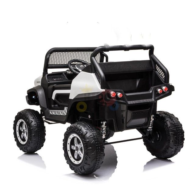 This children’s ride-on car is a small, white 12V/4X4 Mercedes Unimog Junior UTV with large tires, open seating, steering wheel, and realistic details like rear lights and a front bumper. It resembles a rugged ATV.