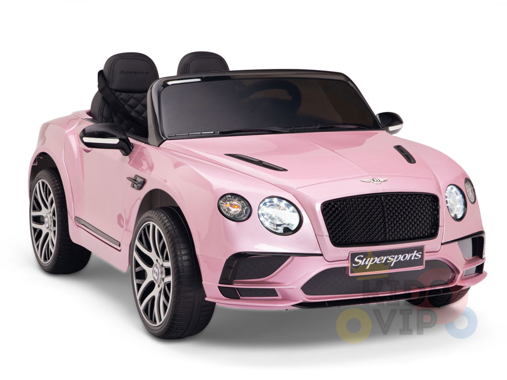 The Pink 12V Bentley GTC Kids Licensed Ride On Car features a stylish design with black windshields, side mirrors, detailed headlights, and a large front grille displaying Supersports. Ideal for young drivers, it includes rubber wheels and a parental remote control.
