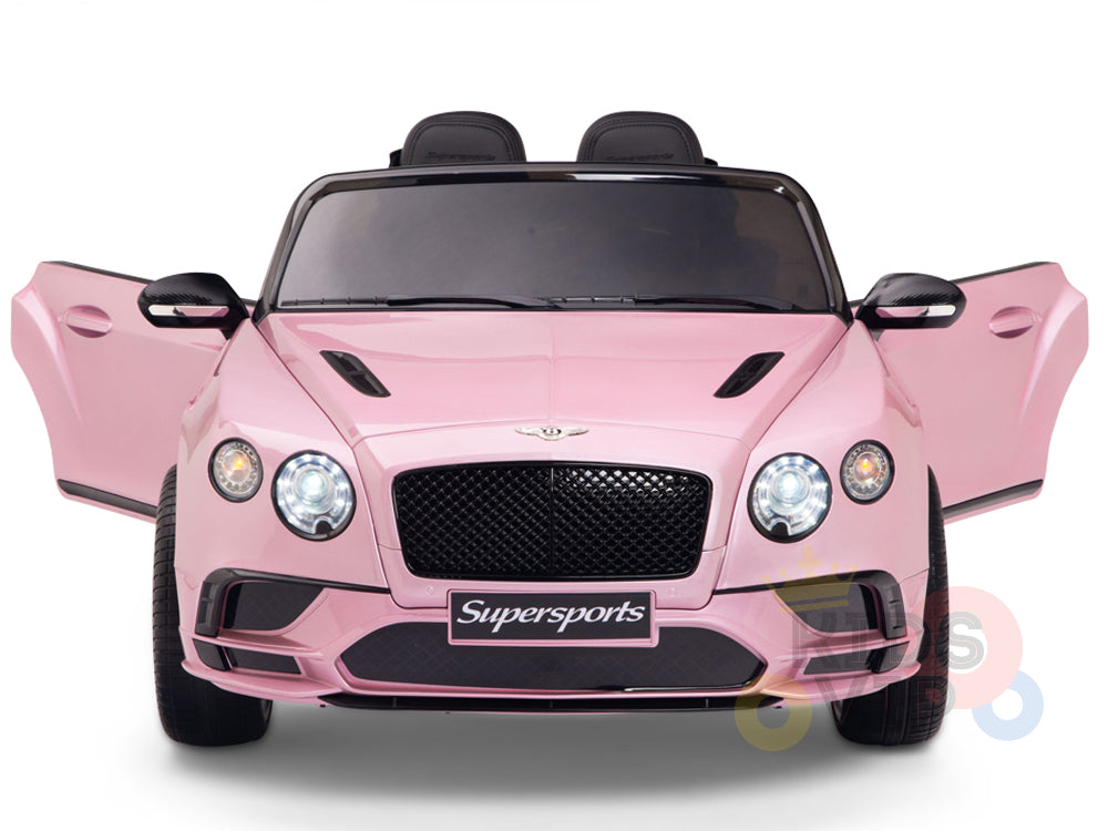 A front view of a pink convertible toy car with open doors, the Pink 12V Bentley GTC Kids Licensed Ride On Car, showcases a sleek Bentley Continental Sport Edition design with black accents and a Supersports label. Two seats inside promise fun for little drivers, complete with parental remote control.