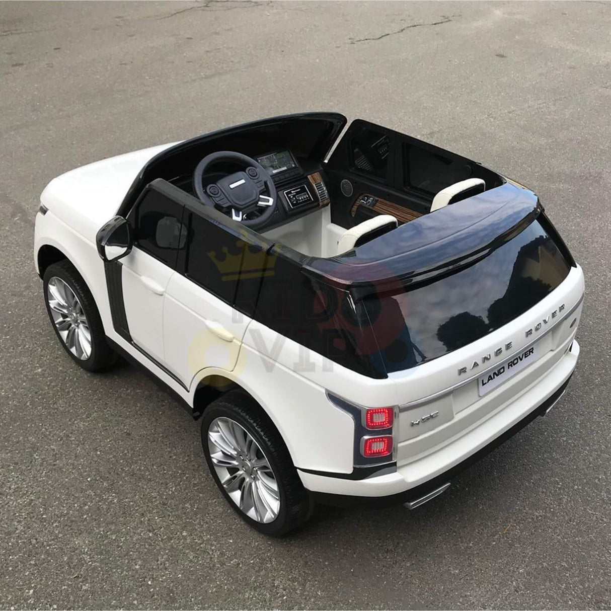 The 24V Complete White on White Edition Range Rover Kids Ride-On Car features a realistic design with white body, black accents, shiny wheels, and technology including RC and MP4. It has two seats and an interior with a steering wheel and dashboard.
