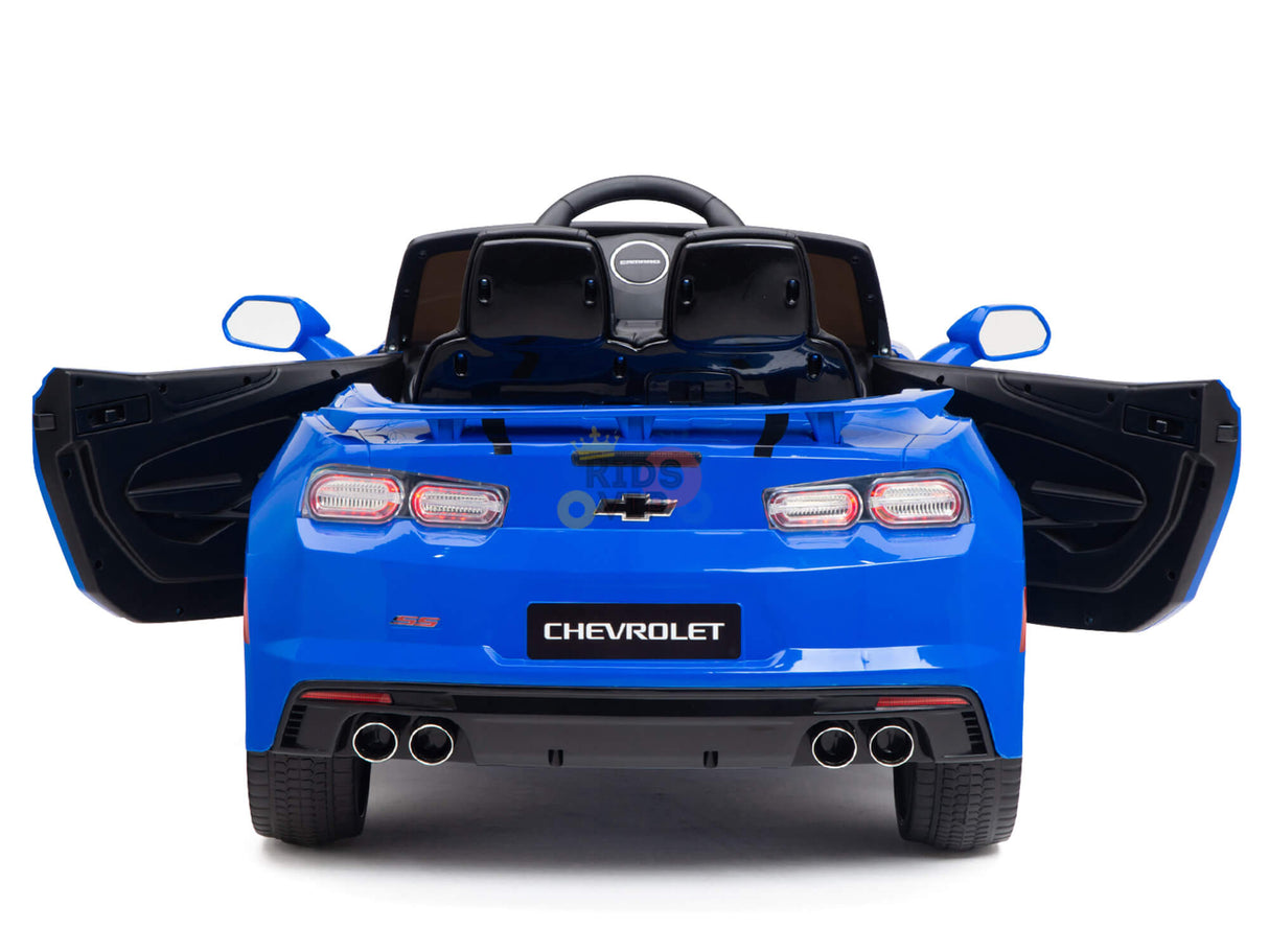 The Blue Official Sport 12V Chevrolet Camaro Kids Ride features scissor doors, a steering wheel, two black seats, dual exhaust pipes, and the iconic logo. It embodies sleek sports car aesthetics with Bluetooth connectivity for added fun, making it perfect for toddlers.