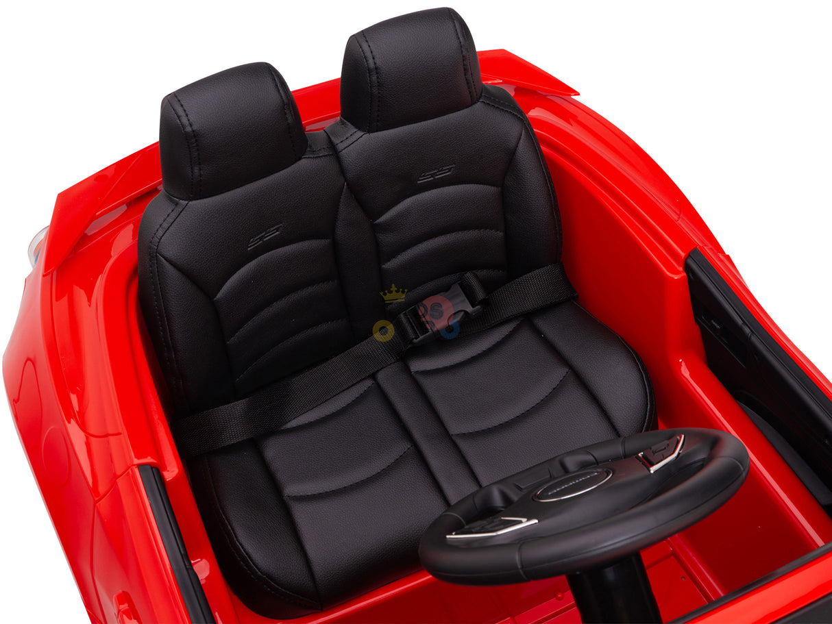 The Red 12V Official Sport Chevrolet Camaro Kids and Toddlers Ride-on Car features a detailed interior with two black leather seats, intricate stitching, seat belts, and logo steering wheel. The simple dashboard and 12V battery ensure endless fun.