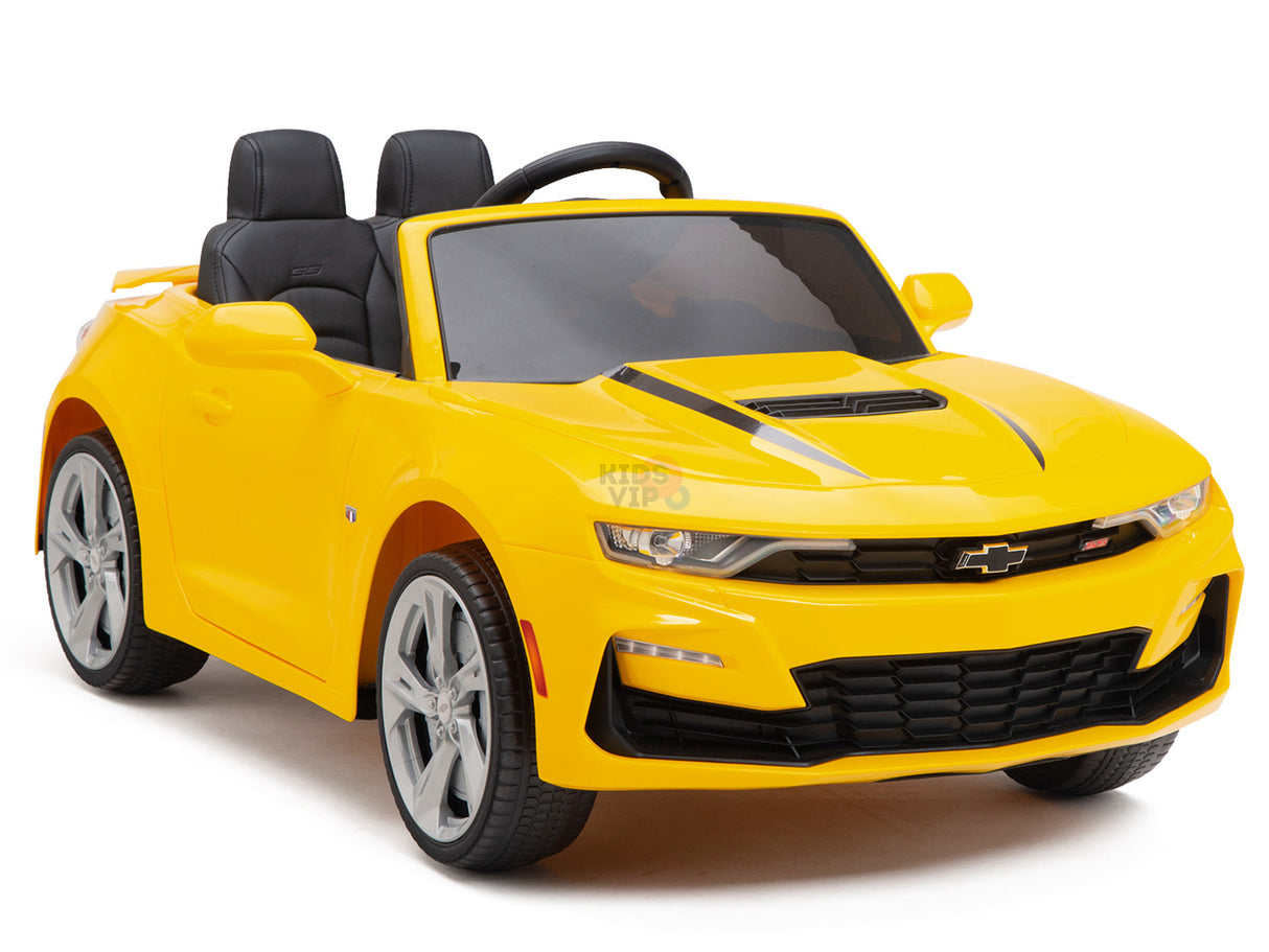 The Yellow 12V Official Sport Chevrolet Camaro Ride-on Car for kids features a sleek black interior, silver wheels, side mirrors, and a detailed grille. Enjoy parental control with the remote feature in this toy convertible closely resembling a real Camaro.