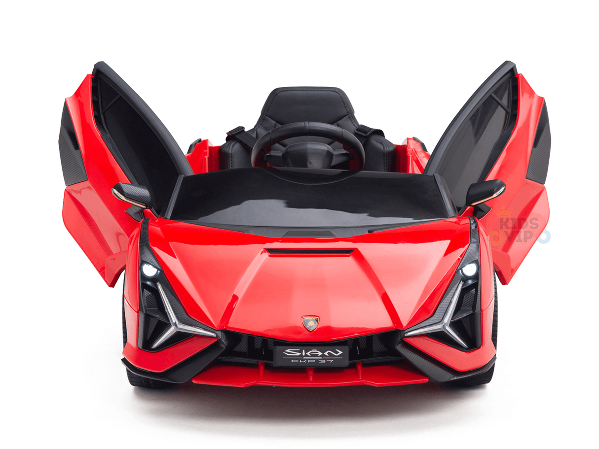 The Red Official 12V Sport Edition Lamborghini Sian Kids Ride On Car showcases butterfly doors, a sleek design, black detailing on the steering wheel and sporty seat, angular headlights upfront, and a logo on the bumper.
