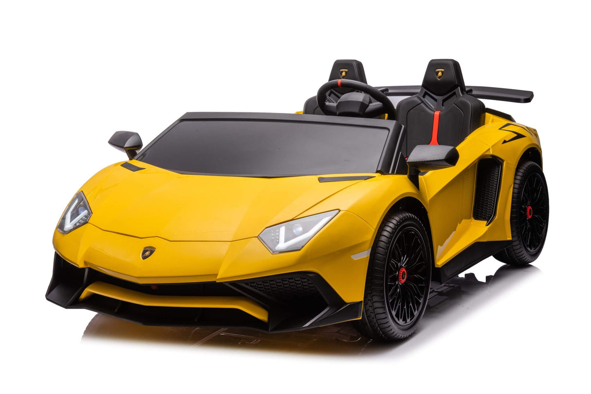 The Yellow 24V/180W Lamborghini SV Limited XXL Edition is a sleek toy car resembling a two-seat ride-on Lamborghini, featuring a steering wheel, detailed headlights, black wheels, and eco-leather seats with red trim for an authentic sports car feel. It can reach speeds up to 10MPH!.