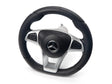 The Enhance Your Driving Experience with a 12V Mercedes GLC Steering Wheel Upgrade is a black and silver wheel featuring a three-pointed star logo, side spoke multi-function buttons, and a sleek design, ideal as a replacement for the Mercedes GLC ride-on car.