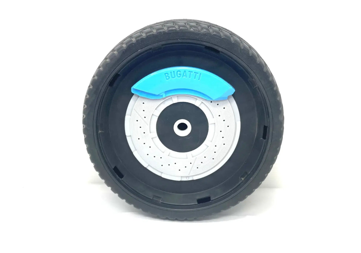 A close-up of a 12V Bugatti Divo rear wheel reveals a detailed black tire with a gray hubcap and blue BUGATTI accent, set against a white background to highlight the sophisticated design, reminiscent of its ride-on car counterpart.