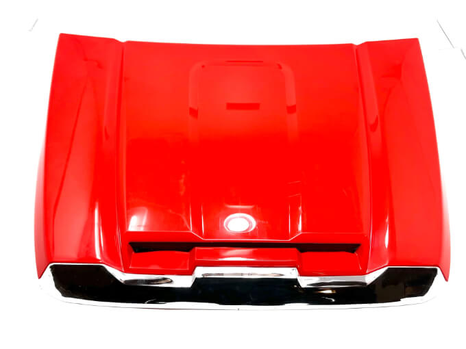 The glossy red Enhance Your GMC Sierra with a 12V/2 Seater Hood showcases sleek lines and indentations for optimal airflow, beautifully isolated on a white background to highlight its impressive craftsmanship.