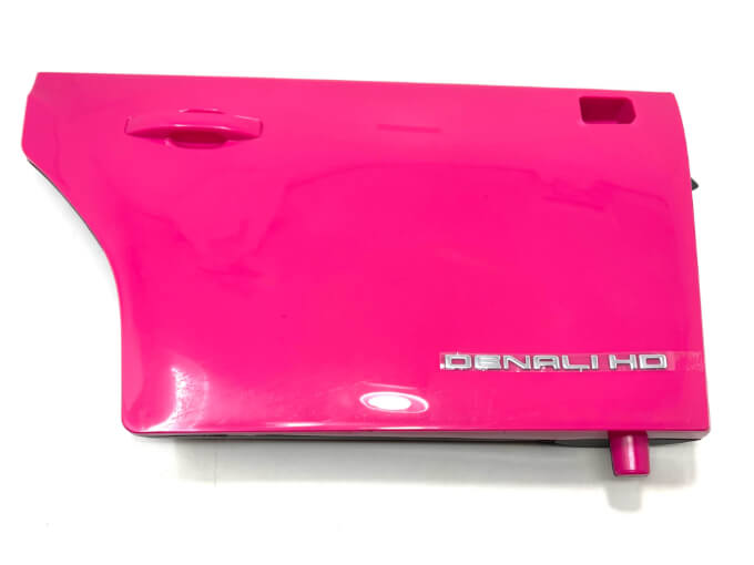 A vibrant, glossy pink passenger side door for a 12V/2 Seater GMC Sierra features a handle and DENALI HD emblem, gleaming against a white background. This high-quality, durable replacement captures the essence of style and power.