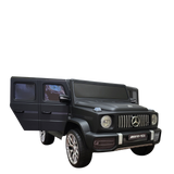 The Limited 12V Matte Edition Mercedes Benz AMG G63 Kids and Toddlers Ride-On Truck, RC is displayed with its drivers door ajar, showcasing a prominent front grille, large alloy wheels, and sleek design. Upgraded technology enhances this ride-on car against a transparent background.