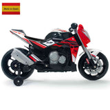 The INJUSA 12V Honda Naked Edition Ride On Bike for kids showcases a vibrant red, black, and white design with training wheels and intricate details. A Spanish flag and Made in Spain text adorn the top left corner, offering young riders an exciting adventure.