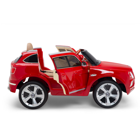The Red 12V Bentley Bentayga Kids Licensed 1 Seater Ride On Car features rubber wheels, an opening door design, and a beige interior with leather seats. Equipped with mirrors and headlights, its designed for childrens use and includes a remote control.
