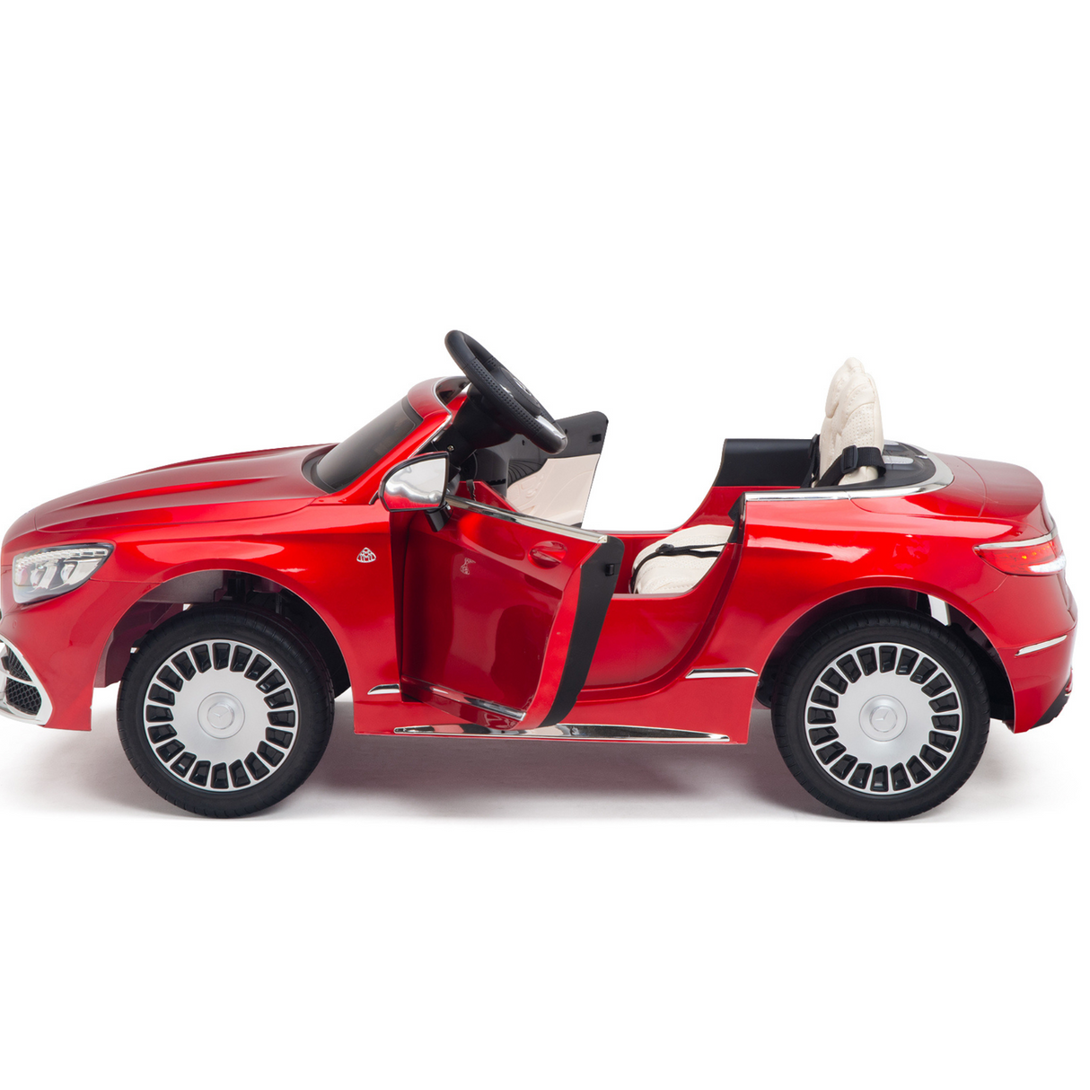 The Red 12V Mercedes Benz Maybach S650 Kids 1 Seater Ride On Car, with its open top and detailed rubber wheels, features a black steering wheel and an ajar drivers door revealing a small beige seat, offering a true KIDS VIP experience.