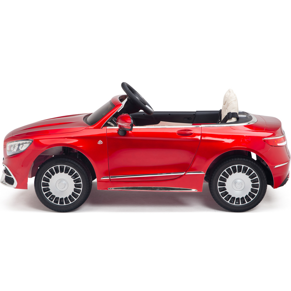 The Red 12V Mercedes Benz Maybach S650 Kids Ride-On Car features a shiny finish, open-top design, black steering wheel, detailed silver rims on rubber wheels and offers a sleek sporty appearance. Its a one-seater with a remote for parental control.