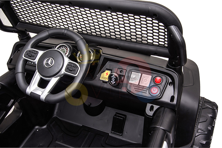 The Camo 12V/4X4 Official Mercedes Unimog Junior Ride On UTV has an interior with a steering wheel, dashboard controls, gear shift, and speedometer. Its mesh-style windshield and vibrant panel buttons embody the rugged essence of a Mercedes-Unimog.