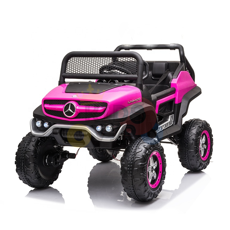 The Pink 12V/4X4 Official Mercedes Unimog Junior Ride On UTV has large rugged wheels, mesh grille, open-top design, headlights, and seating for children. Its perfect for adventurous play and can be controlled with a remote.