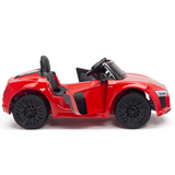 A sleek Red 12V Audi R8 Licensed 1-Seater Ride On Car with black seats and upgraded rubber EVA wheels is shown from the side. The open drivers door reveals its sporty interior, including the steering wheel and dashboard.