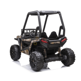 The Camo 2 Seats Golf Buggy 24V Edition Kids Ride On Car features a black frame, camo body, rubber wheels, roll cage, dual seats, and realistic rear lights. Seen from the back on a white background, it resembles a toy off-road vehicle.