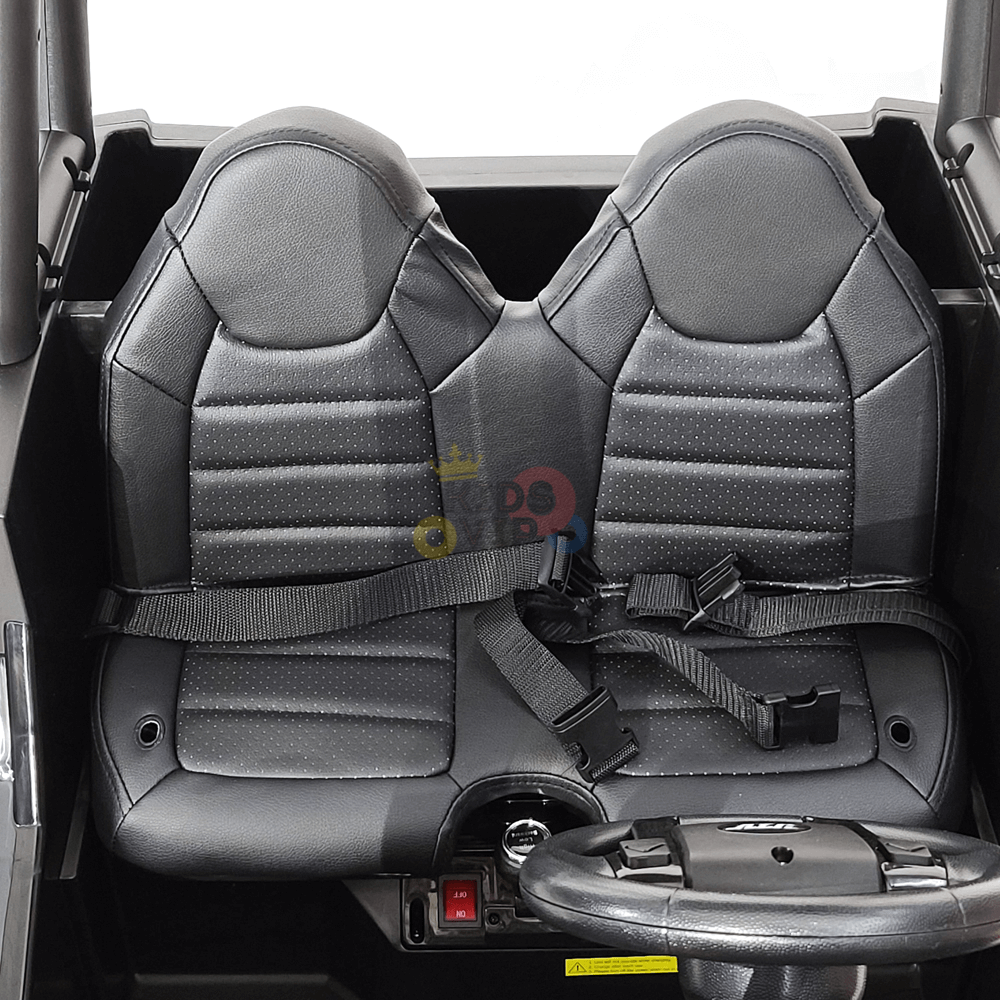 The 2 Seats Golf Buggy 24V Edition Kids Ride On Car UTV with RC features black car seats sporting a textured pattern and seat belts, set in a grey interior. A steering wheel for parental remote control ensures added safety, making it perfect for kids.