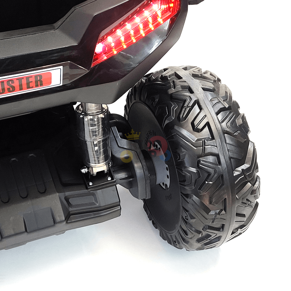 A close-up of the rear section of the 2 Seats Golf Buggy 24V Edition Kids Ride On Car UTV with RC, Rubber Wheels shows rugged tread tires, glowing red LED tail lights, and part of a branded sticker against a white background.