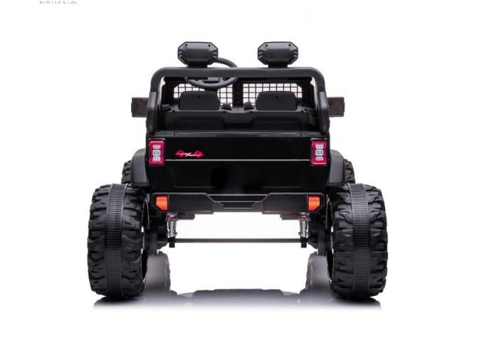 A rear view of the Black 24V/2WD Xtreme Edition Ride-on Truck showcases oversized tires, a rugged design, and detailed taillights. With Eva wheels, leather seats, and a visible suspension system, it offers a realistic look for adventure-loving kids.