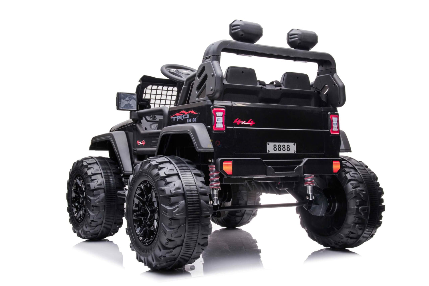 The Black 24V/4WD Xtreme Ride-on Truck, equipped with EVA wheels and leather seats, is shown from the rear. It has 8888 on the license plate, red accents, and a roll bar. Photographed against a white background, it highlights its bold design.
