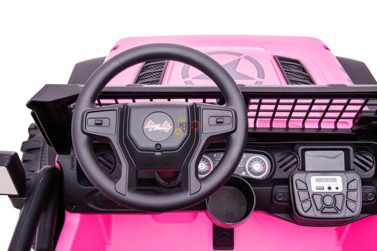 A close-up of the pink 24V/4WD Xtreme Ride on Trucks dashboard shows a black 4x4 steering wheel, buttons, dials, and digital display, all easily controlled by parental remote.