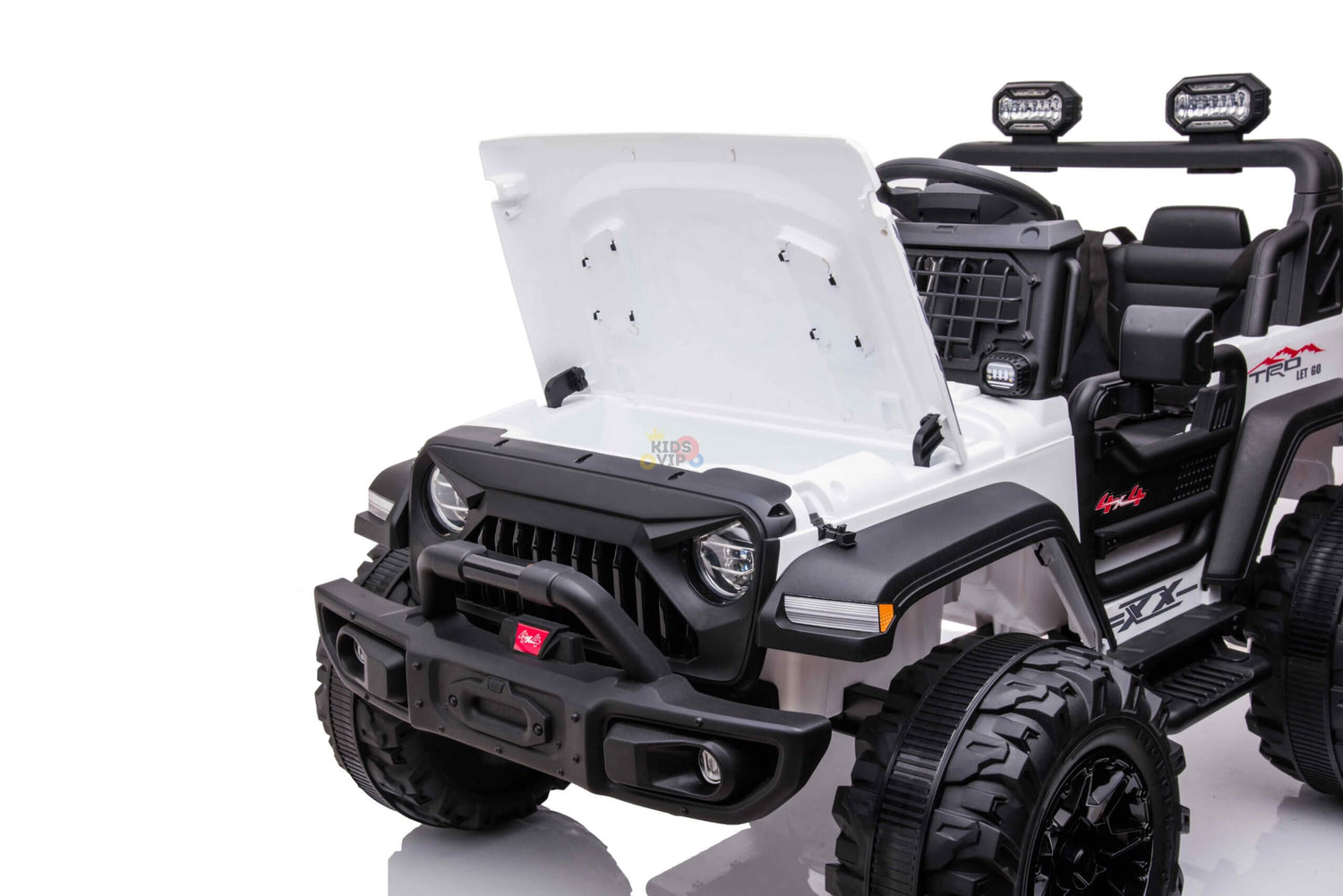 The White 24V/4WD Xtreme Ride on Truck features Eva Wheels, leather seats, black details, large wheels, and a roll bar with lights. This toy Jeep-style ride-on car is parked on a glossy surface, highlighting its front and side profile with an open hood.
