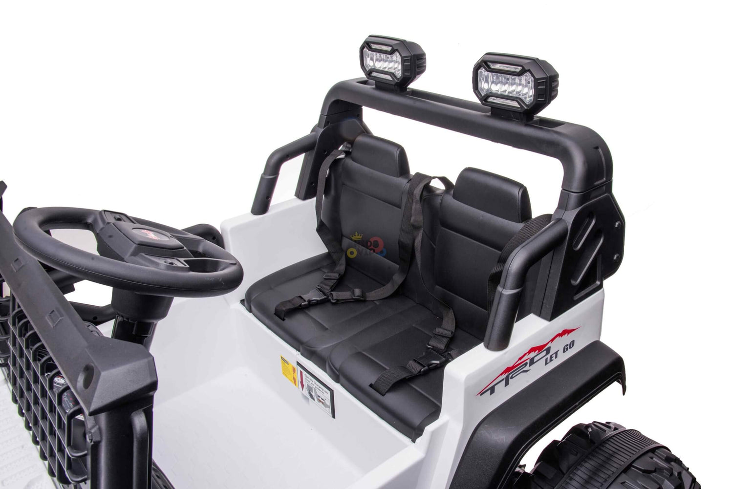 The White 24V/4WD Xtreme Ride on Truck features black accents, EVA wheels, two black leather seats with seat belts, a steering wheel, a dashboard, and overhead lights for an adventurous ride.