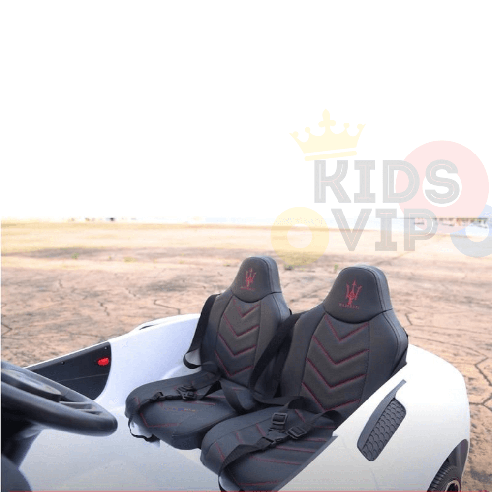 The Experience Luxury: Pink XXL 24V Maserati MC20 ride-on vehicle features premium details, including black and red leather seats with logos, a left-side steering wheel, and a Kids Vip logo. Perfectly positioned in an open area under a clear sky, its design exudes luxury.