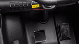 Close-up view of the Red 24V/180W Lamborghini SV Limited XXL Edition ride-ons dashboard, showing a Charging Port labeled in red text, next to a button panel. The black textured surface enhances the premium feel of this Kids VIP vehicle, reaching speeds up to 10 MPH!.