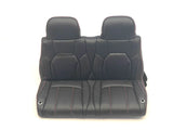 The 12V Lexus Seat is a black double car seat with red stitching, modern design, upholstery patterns on the backrest and seat, and integrated headrests. Positioned against a plain white background. Dont miss out—this is a final sale item; contact us for more details!.