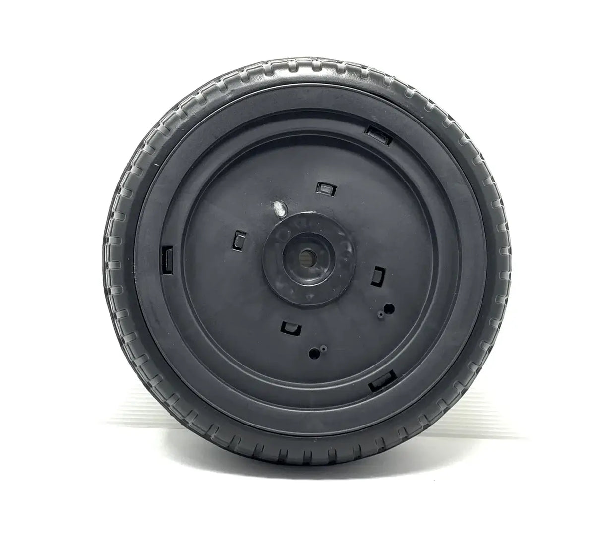 The 12V Lexus Tire, a black round wheel for a ride-on car, features a textured rubber surface and central hub with several small openings. Set against a plain white background, this final sale accessorys details are beautifully highlighted.