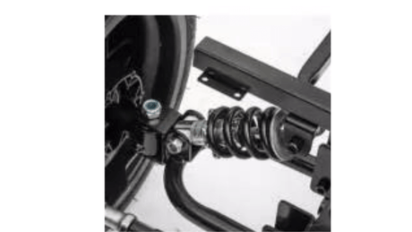 Close-up of a horizontal spring suspension on the Yellow 24V/180W Lamborghini SV Limited XXL Edition ride-on. Attached to a black metal frame, it connects to the wheel assembly for smooth travel across various terrains, reaching speeds up to 10MPH.
