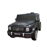 Limited 12V Matte Edition Mercedes-Benz AMG G63 Kids Ride-On Truck, RC, with AMG logo features detailed headlights, grille, silver rims, and black-tinted windows against a solid black background.